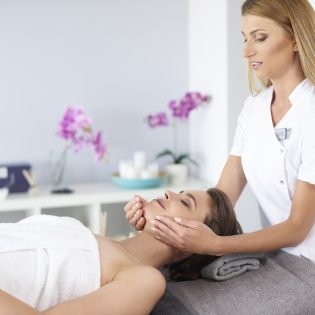 Beautiful woman during facial massage