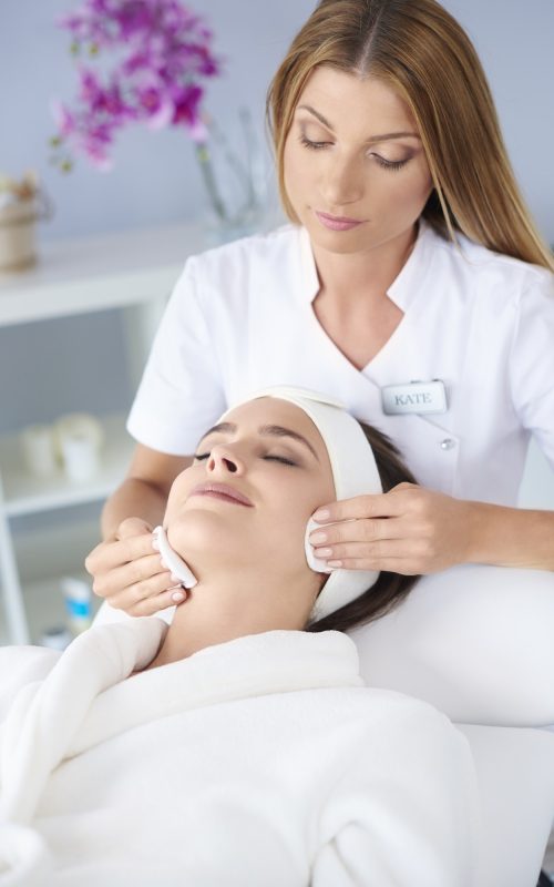 Beautiful woman doing facial her client